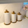 Inspire Me! Home Decor White Ceramic Jars With Gold Flower Lid (3 Sizes) 2 Inspire Me! Home Decor White Ceramic Jars With Gold Flower Lid (3 Sizes)